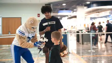 Trey and Cosmo play games on WVU campus