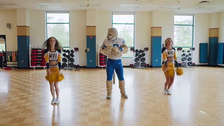 Cosmo learns a cheer from WVU cheerleaders